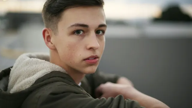 A teenager glancing back over his shoulder